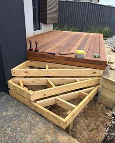 a wooden deck being built with tools on it