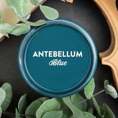 an antebellum blue tin sitting on top of green leaves