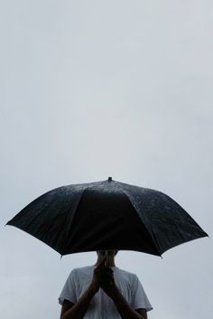 a person holding an umbrella over their head