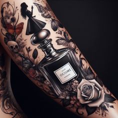 a woman's leg with tattoos and a perfume bottle on it