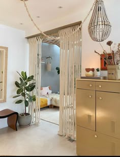 a living room filled with furniture and a chandelier hanging from the ceiling next to a door