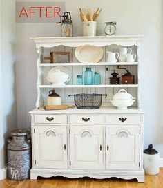 a white china cabinet with dishes on top