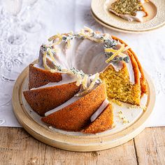 a bundt cake on a wooden plate with one slice cut out and the other half eaten