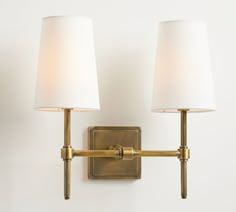 two lamps mounted on the wall next to each other