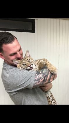 a man holding a cat in his arms