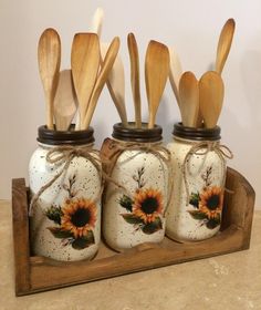 wooden spoons and utensils in painted mason jars with sunflowers on them