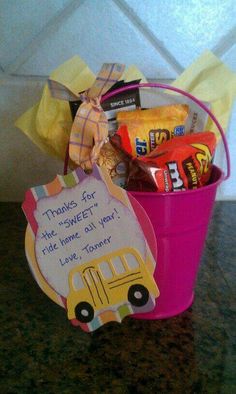 a pink bucket filled with candy and candies