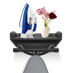 an ironing board and vase with flowers on it