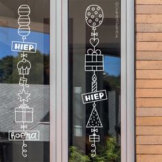 a window with stickers on it that say help and present boxes in different languages