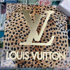 the louis vuitton logo is on top of a leopard print material with gold foil