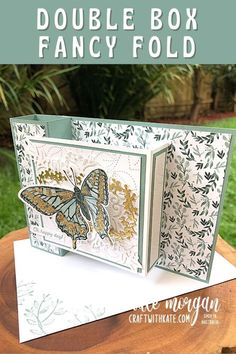 a card with a butterfly on it and the words, double box fancy fold