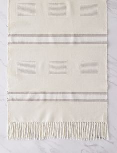 a white and grey striped towel laying on top of a table