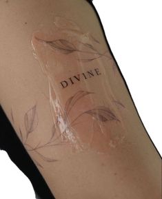 a woman's arm with the word divine written on it