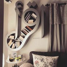 a living room filled with furniture and a book shelf next to a wall mounted clock