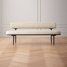 a white bench sitting on top of a hard wood floor