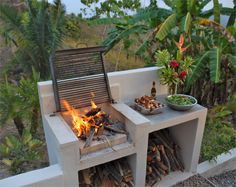 an outdoor grill with fire and food on it