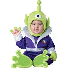 a baby in a costume sitting on the ground with his hands up and eyes wide open