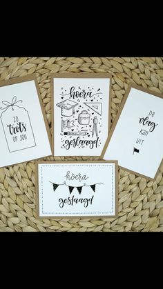 three cards with black ink on them sitting in a basket