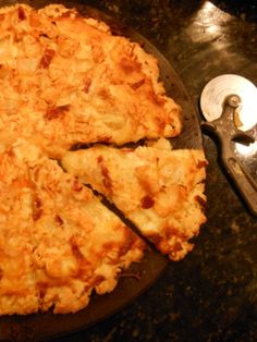 a pizza sitting on top of a pan covered in cheese