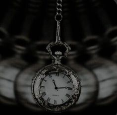 an old pocket watch hanging from a chain