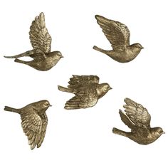 four bronze birds flying in the air