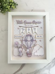 a baby's birth card with a hot air balloon in the sky and clouds