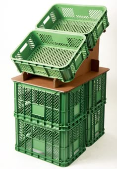 three green plastic crates stacked on top of each other