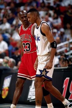 two basketball players standing next to each other