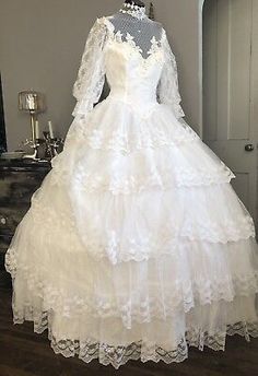 a white wedding dress on display in a room