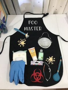 a black apron with various items on it and the words poo master written on it