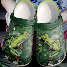 a pair of green shoes with a frog painted on them