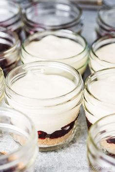 several jars filled with desserts sitting on top of a table