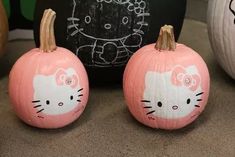 two pumpkins with hello kitty painted on them