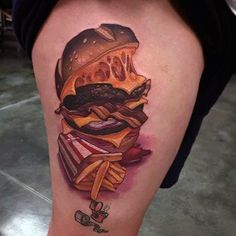 a tattoo with a hamburger and french fries on it