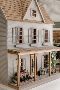 a model house with lots of windows and plants