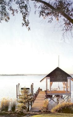 a gazebo sitting on top of a wooden pier