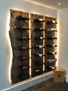 a wine rack made out of wooden planks in a room with lights on the wall