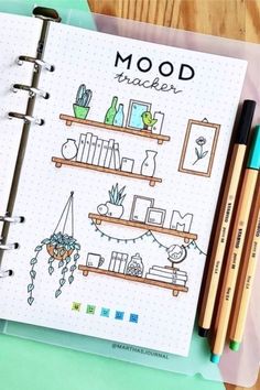 an open notebook with doodles and markers on it