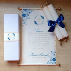 the wedding stationery is laid out on top of a table with blue and white flowers