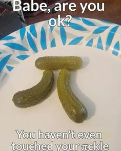 two pickles sitting on top of a white plate with words above it that say, babe, are you ok?