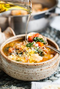 a bowl of soup being poured into it