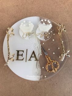 a pair of scissors sitting on top of a glass plate with the word eia spelled out