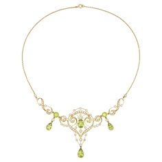 An Edwardian peridot and pearl necklace, to the centre an oval faceted peridot measuring 10x7mm millegrain-set to yellow gold collet, surrounded by gold openwork scroll-design frame embellished with small half pearls, and suspending a pear-shaped faceted peridot measuring 11.5 x 7mm, on each side connected with a peridot and pearl drop link, terminating to a figure-of-eight gold link set with half-pearls, mounted in 15ct gold, all suspended by a gold trace chain with bolt ring clasp, circa 1910, Fine Jewelry Peridot Necklace For Anniversary, Art Nouveau Jewelry Silver, Formal Peridot Gemstone Necklaces, Vintage Gold Peridot Jewelry, Peridot Necklace Vintage, Luxury Peridot Pendant Necklace, Whimsical Jewelry, Edwardian Jewelry, Peridot Necklace