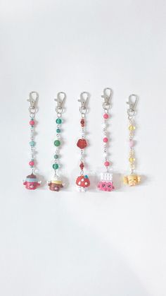 six charms with different designs on them sitting in front of a white background and one has a keychain attached to it