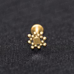 a gold beaded ring on a black surface