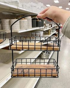 a person is holding two baskets in the store