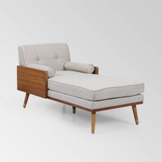 the chaise lounge chair is made from wood and fabric, with a white upholstered back