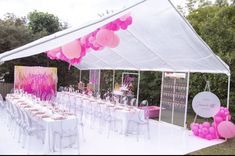 a party tent set up with tables and chairs for an outdoor event, decorated with pink balloons