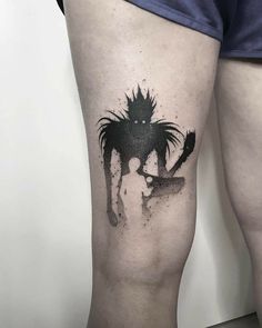 a person with a tattoo on their leg that has an image of a woman holding a knife