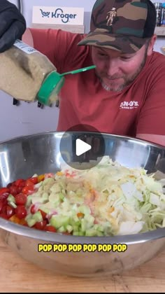 a man in a red shirt is making a salad